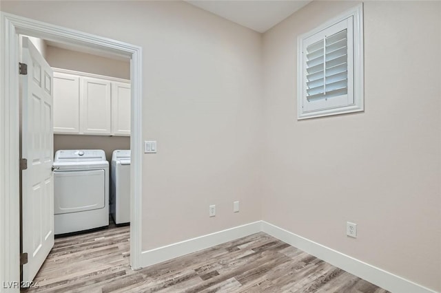 10315 Premia Pl, Las Vegas, NV 89135 - laundry room with washer and clothes dryer, light wood-style flooring, and cabinet space