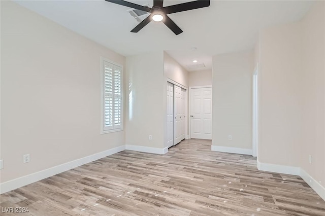 unfurnished bedroom featuring light hardwood / wood-style floors, a closet, and ceiling fan