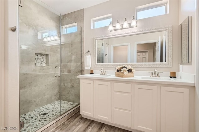 bathroom featuring a shower with door, vanity, and hardwood / wood-style flooring