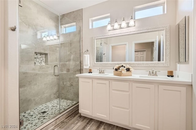 10315 Premia Pl, Las Vegas, NV 89135 - full bathroom featuring a shower stall, double vanity, and wood finished floors