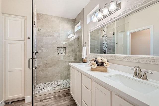 bathroom featuring walk in shower, vanity, and hardwood / wood-style floors