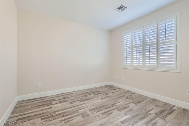 empty room with light hardwood / wood-style flooring