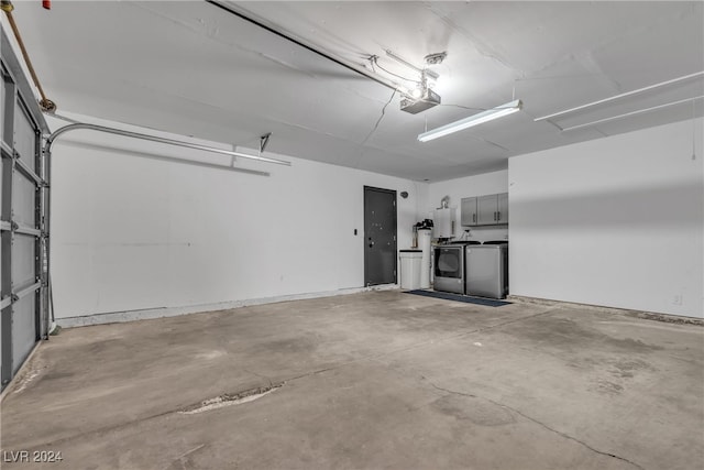 garage featuring washing machine and dryer and a garage door opener