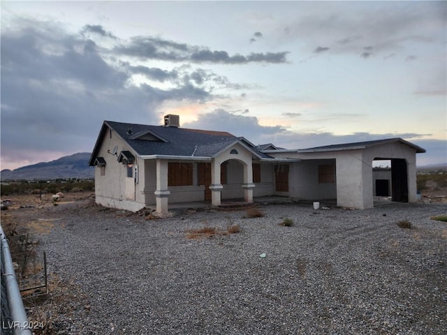 view of front of house with a mountain view and stucco siding