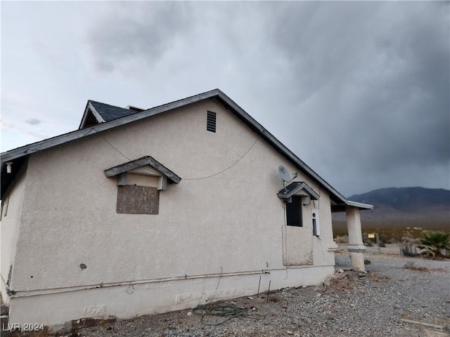 view of property exterior with a mountain view and stucco siding