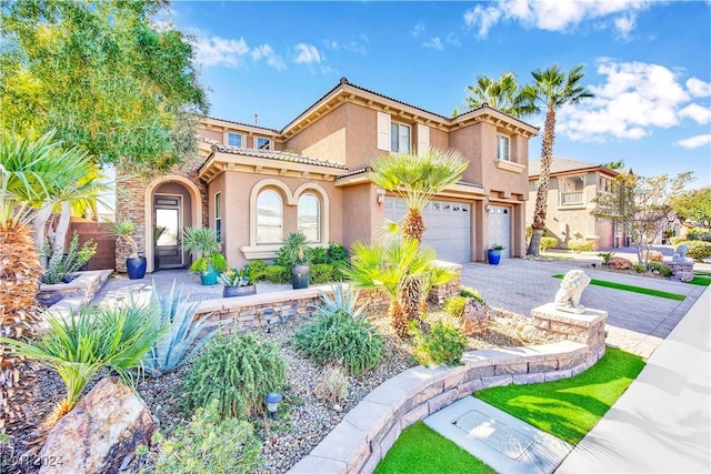 127 Birch Ridge Ave, Las Vegas, NV 89183 - mediterranean / spanish home with stucco siding, an attached garage, a tile roof, and driveway