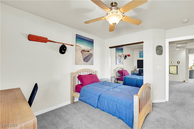 carpeted bedroom with ceiling fan and a closet