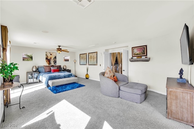 living room with ceiling fan and carpet flooring