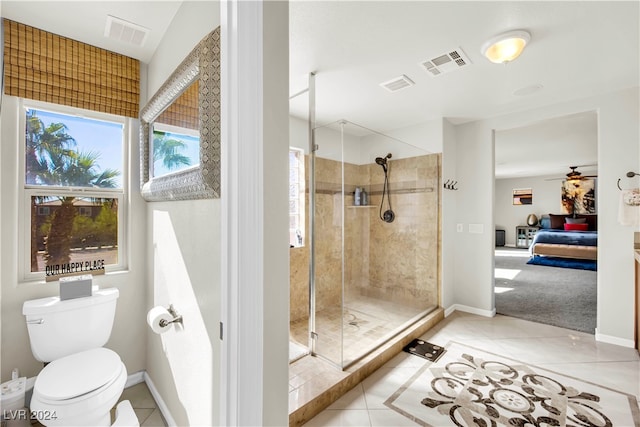 bathroom featuring walk in shower, tile patterned floors, toilet, and ceiling fan