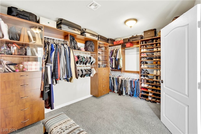 walk in closet featuring carpet flooring