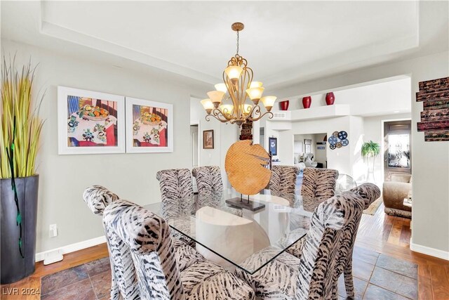 127 Birch Ridge Ave, Las Vegas, NV 89183 - dining space featuring a chandelier, wood finished floors, and a tray ceiling