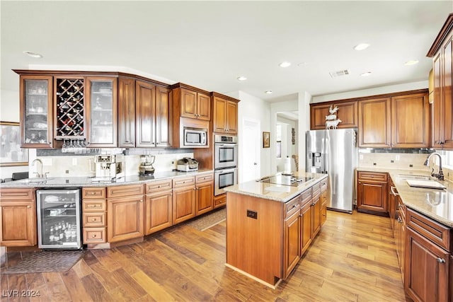 127 Birch Ridge Ave, Las Vegas, NV 89183 - kitchen featuring beverage cooler, appliances with stainless steel finishes, decorative backsplash, wood finished floors, and recessed lighting