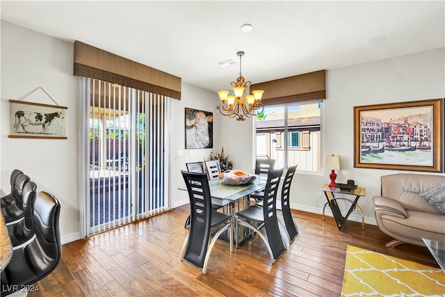 dining room featuring a notable chandelier, hardwood / wood-style flooring, and a healthy amount of sunlight