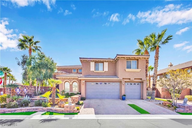 127 Birch Ridge Ave, Las Vegas, NV 89183 - view of front of home featuring stucco siding, asphalt driveway, a garage, and a tiled roof