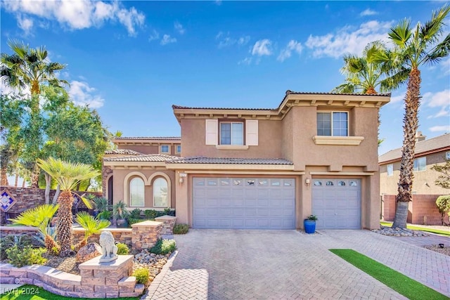 127 Birch Ridge Ave, Las Vegas, NV 89183 - view of front facade featuring stucco siding, an attached garage, driveway, and a tile roof
