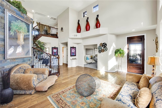 living room featuring a high ceiling and hardwood / wood-style flooring