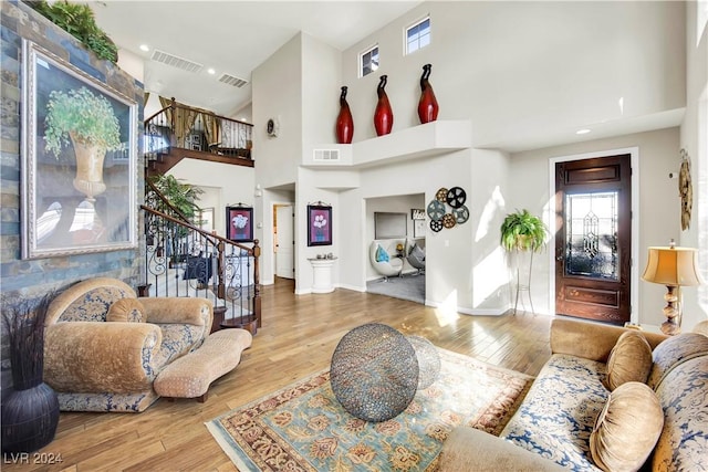 127 Birch Ridge Ave, Las Vegas, NV 89183 - living room featuring stairway, wood finished floors, and a high ceiling