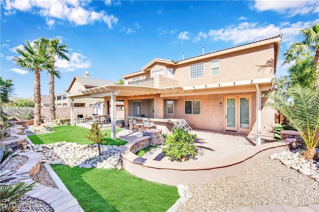 back of property featuring a pergola, a yard, and a patio area