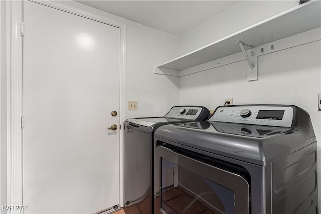 laundry room with washing machine and clothes dryer