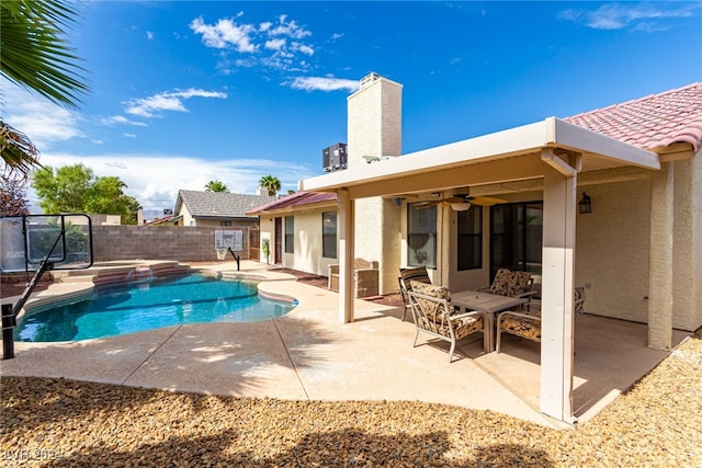 view of swimming pool with a patio and ceiling fan