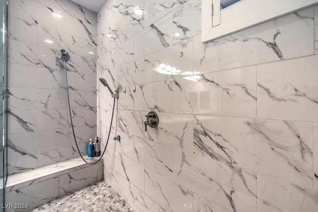 interior details featuring a tile shower