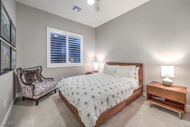 bedroom with ceiling fan, light carpet, and vaulted ceiling