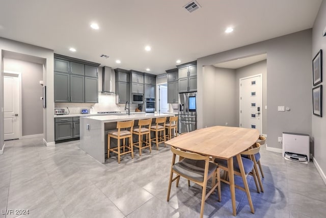 tiled dining room featuring sink