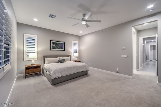 bedroom with ceiling fan and light carpet