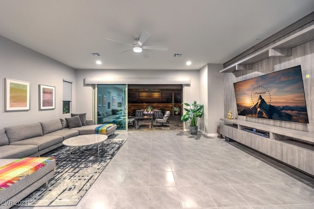 living room with ceiling fan and light tile patterned flooring