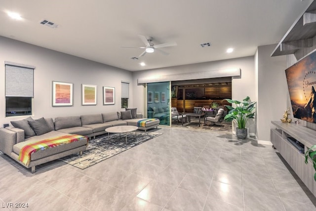 tiled living room with ceiling fan