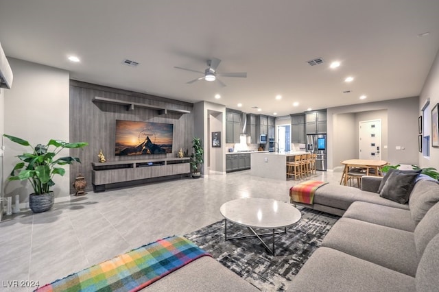 tiled living room with ceiling fan