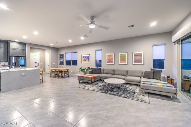 living room with sink and ceiling fan