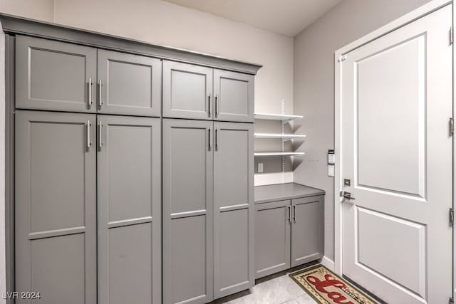 spacious closet with light tile patterned floors