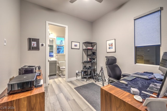 home office featuring light hardwood / wood-style floors and ceiling fan