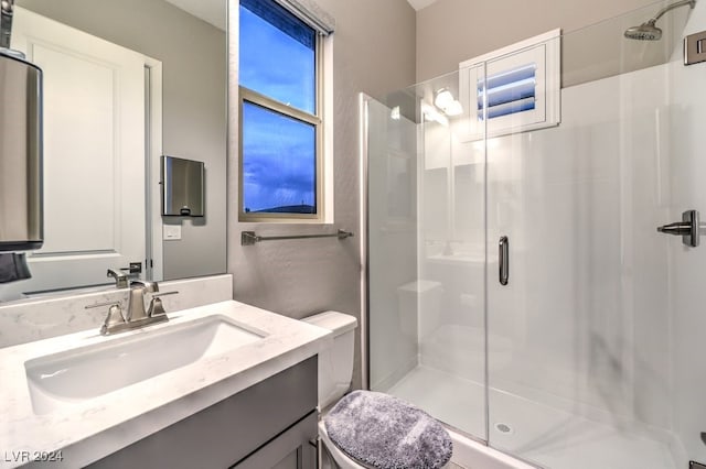 bathroom with vanity, toilet, and an enclosed shower