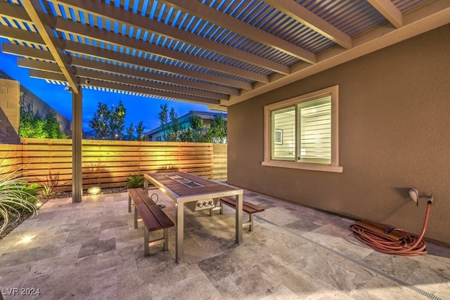 patio at twilight featuring a pergola