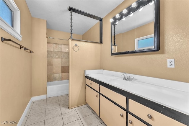 bathroom with tiled shower / bath combo, vanity, and tile patterned floors