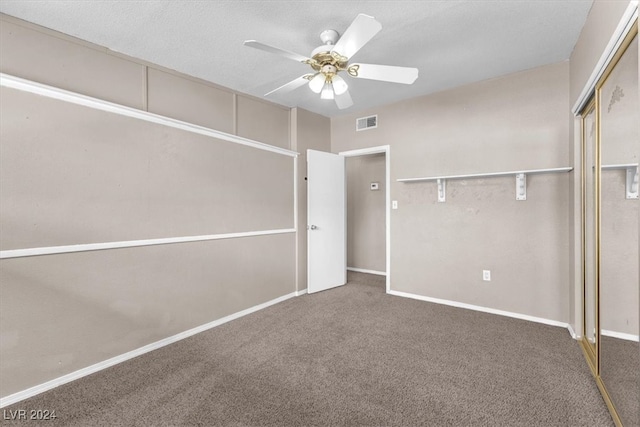 unfurnished bedroom with ceiling fan, carpet floors, and a closet