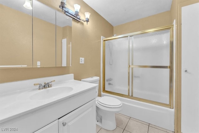 full bathroom featuring vanity, tile patterned floors, toilet, and combined bath / shower with glass door