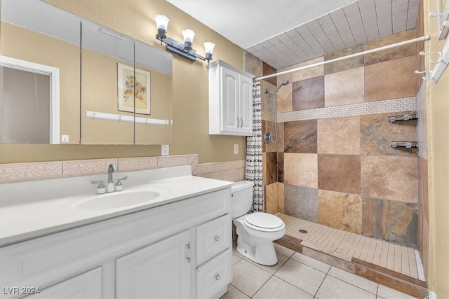 bathroom featuring walk in shower, vanity, toilet, and tile patterned floors