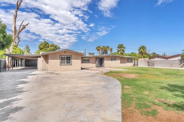 ranch-style house with a front yard and a carport