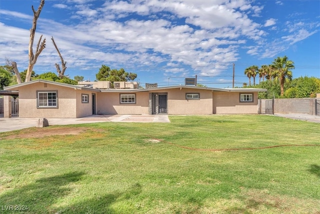 back of property featuring a patio area and a yard