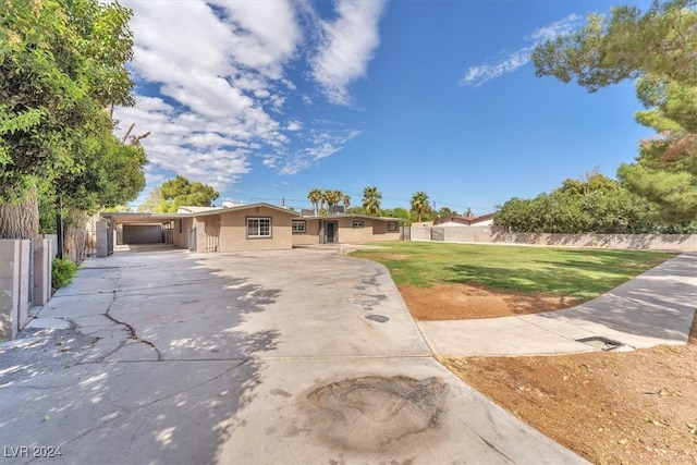 ranch-style home featuring a carport and a front yard