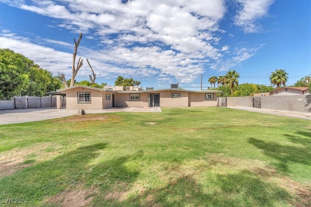 back of property featuring a yard