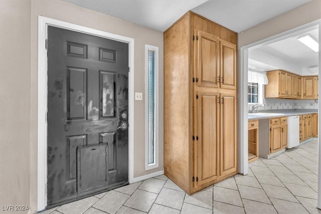 tiled foyer entrance featuring sink