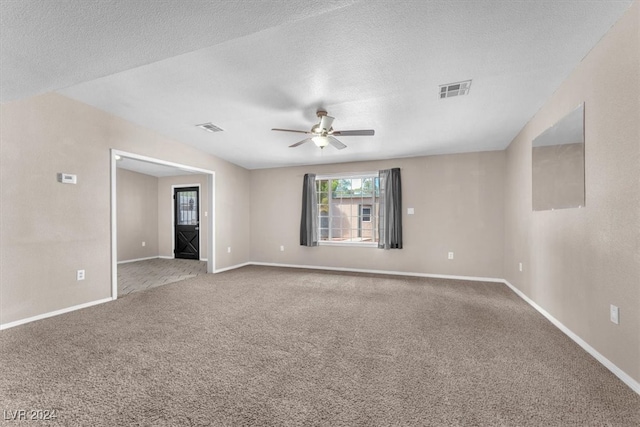 unfurnished room featuring carpet floors, a textured ceiling, and ceiling fan