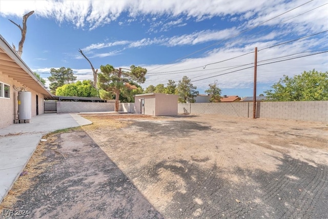 view of yard with a patio and water heater