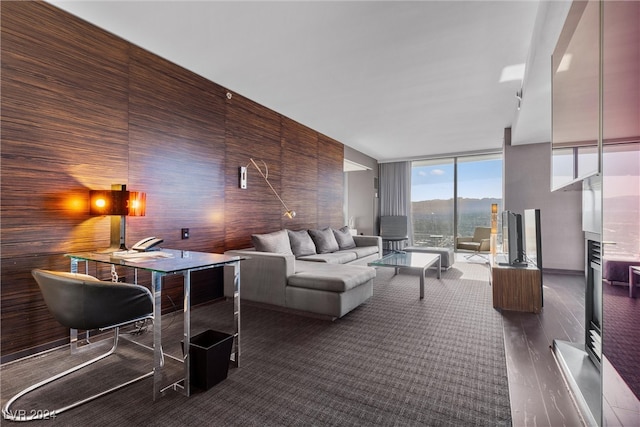 living room featuring a wall of windows, wood walls, and dark hardwood / wood-style flooring