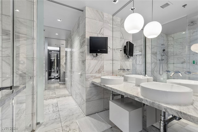 bathroom with tile walls and a shower with door