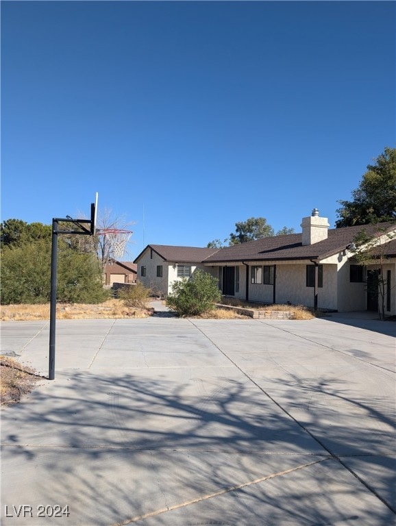 ranch-style home with basketball court